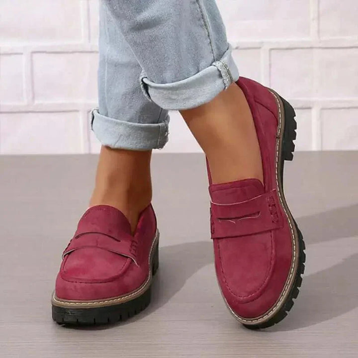 Elegant women's fashion loafers, black chunky slip-ons offering comfort and sophisticated style.