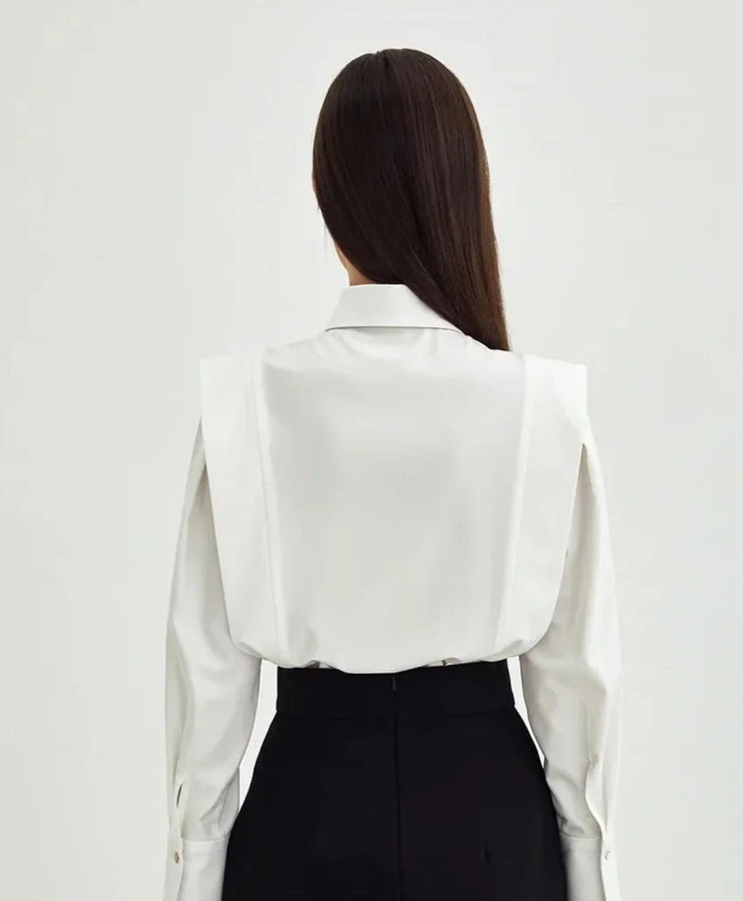 Close-up of the crisp fabric texture on a women's long sleeve button-down shirt.