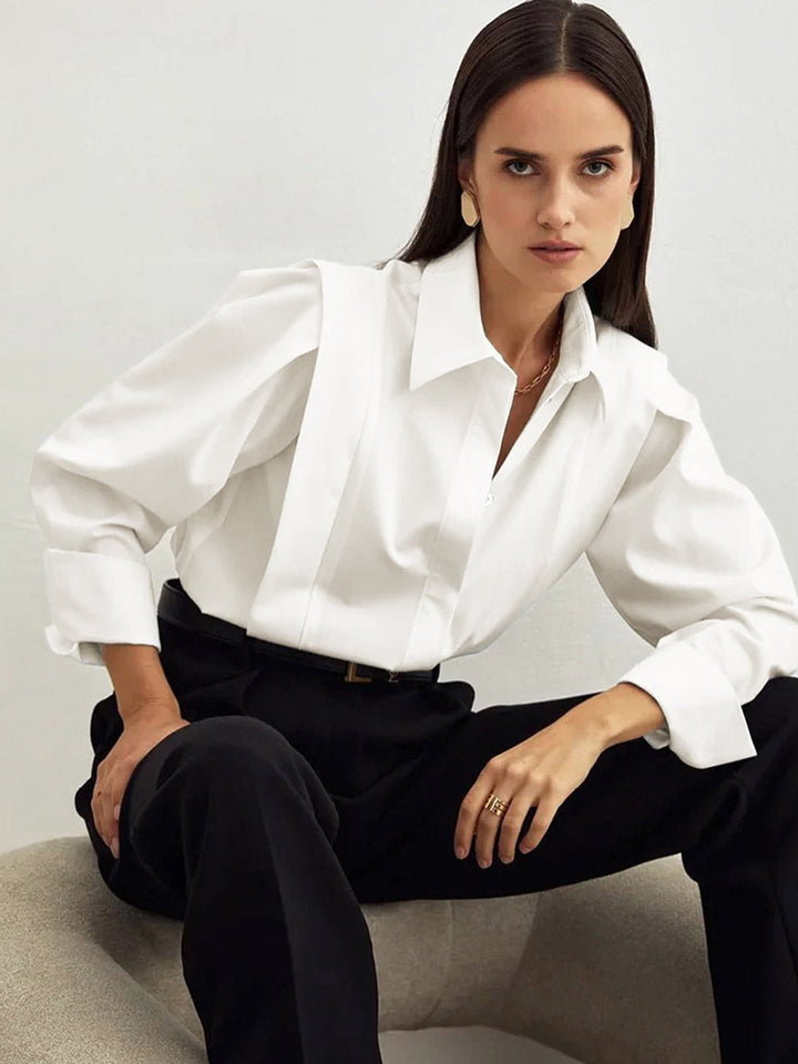 Model wearing a women's elegant button-down blouse, styled for a professional look.