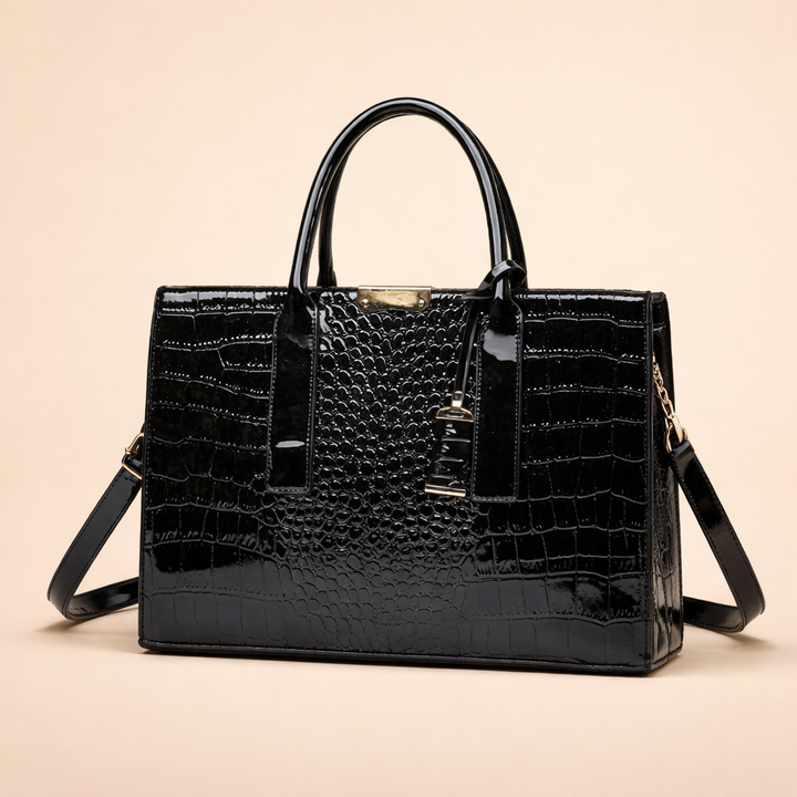 Close-up of a women's luxury style croc-embossed faux leather tote bag. Structured fashion handbag for everyday elegance.
