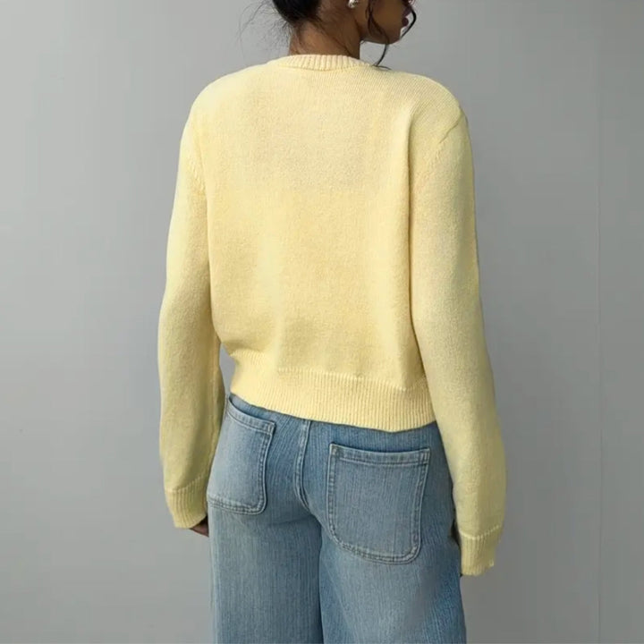 Women's round neck cropped cardigan, with elegant ribbed trim and a fashionable button-front.