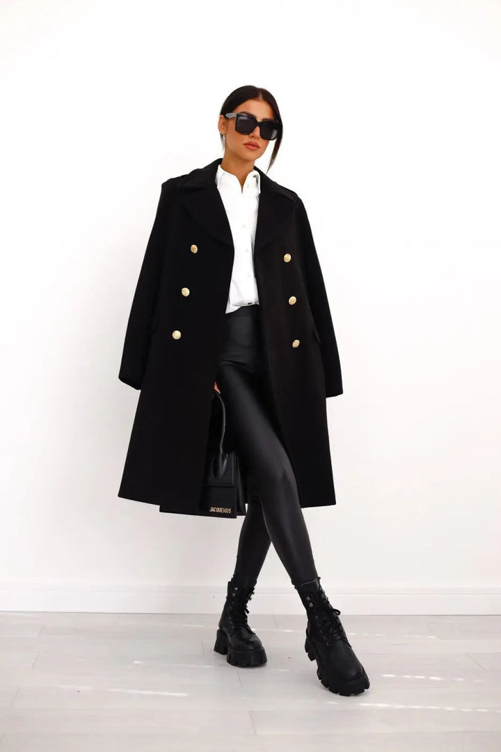 Women's double-breasted long tailored coat with elegant gold buttons.