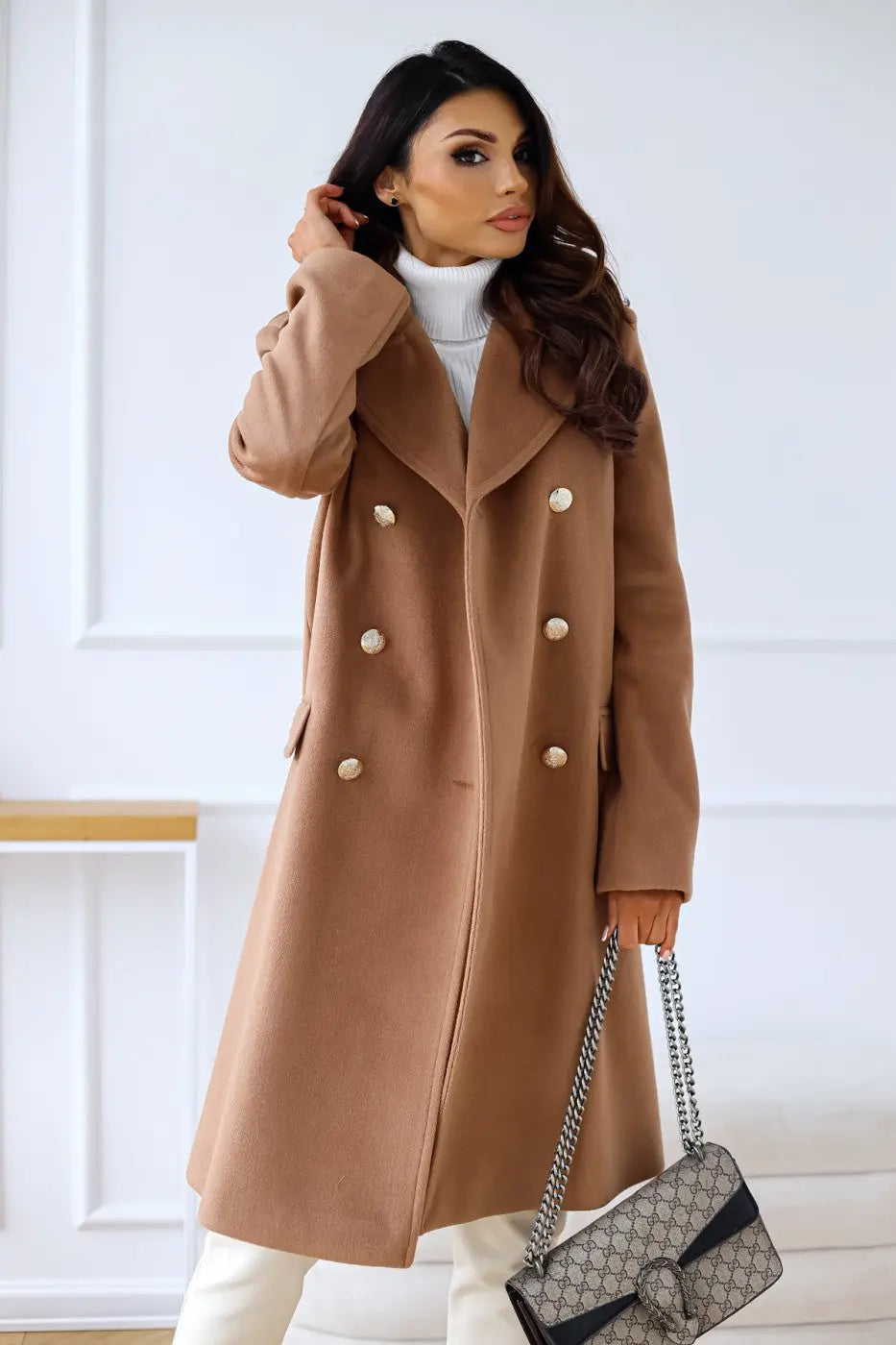 Flattering long tailored women's double-breasted coat with ornate gold buttons, a winter fashion essential.