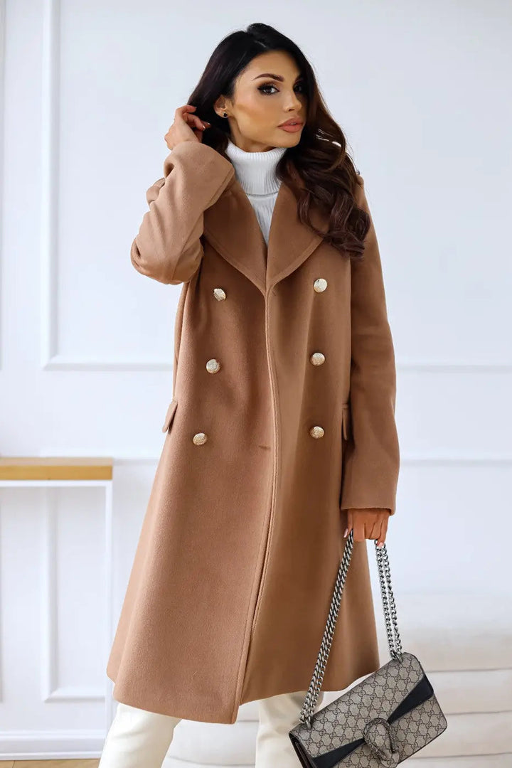 Flattering long tailored women's double-breasted coat with ornate gold buttons, a winter fashion essential.