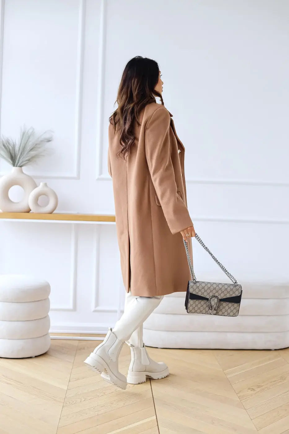 Stylish women's double-breasted long coat with gold buttons, perfect elegant outerwear for cooler weather.