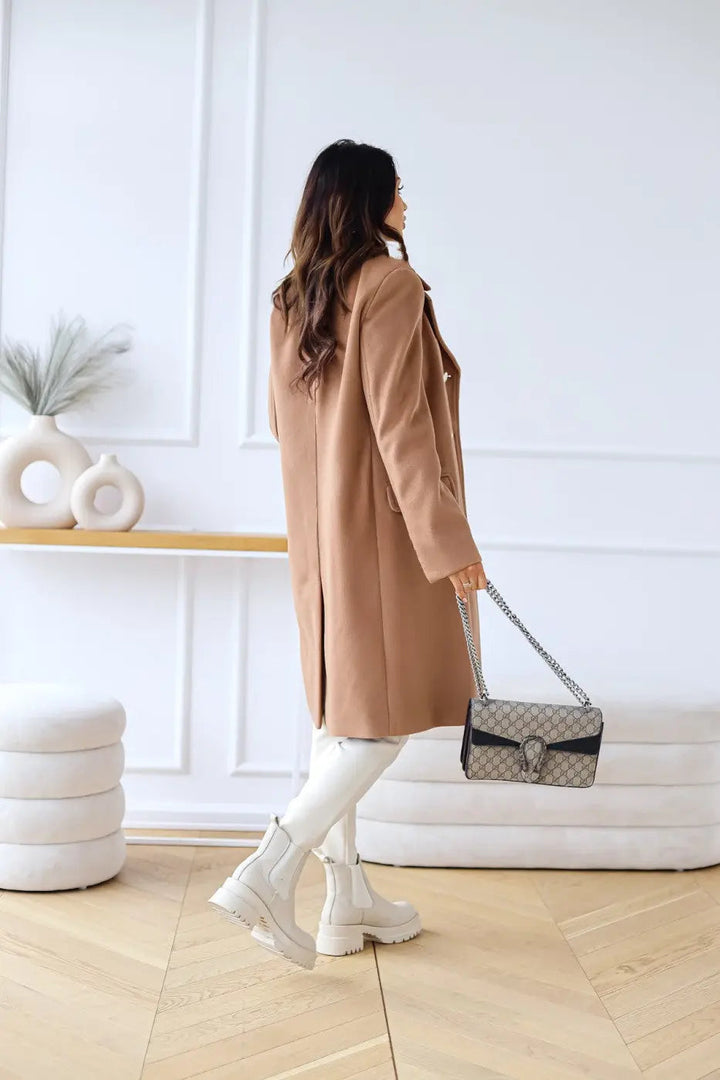 Stylish women's double-breasted long coat with gold buttons, perfect elegant outerwear for cooler weather.