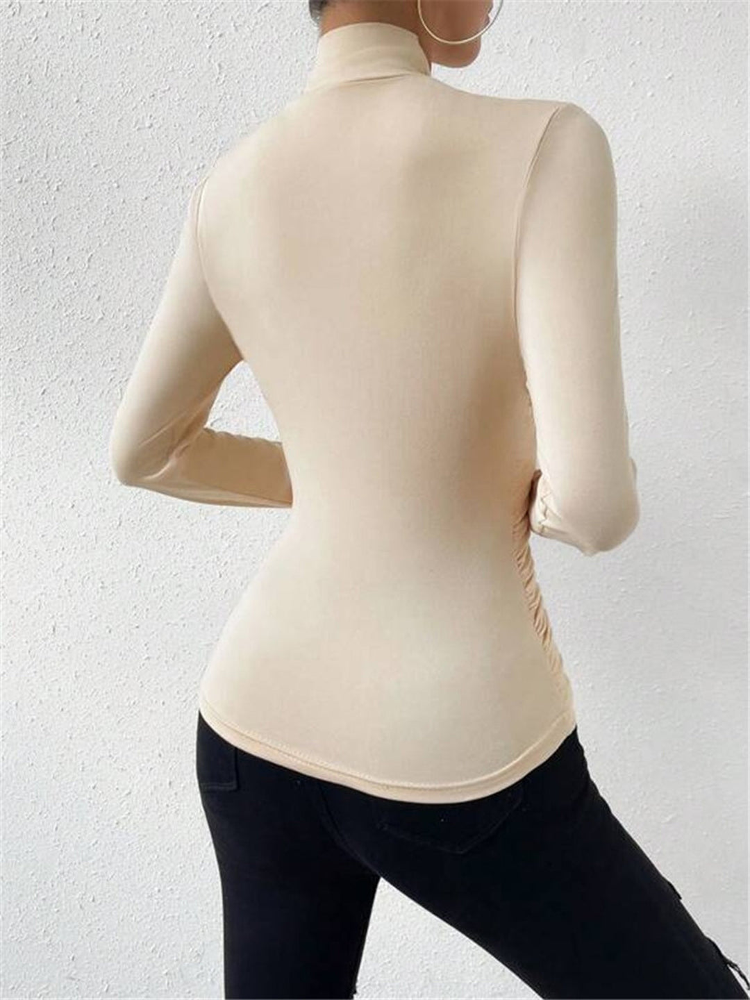 Elegant draped long sleeve top with a flattering crossover neckline for women.