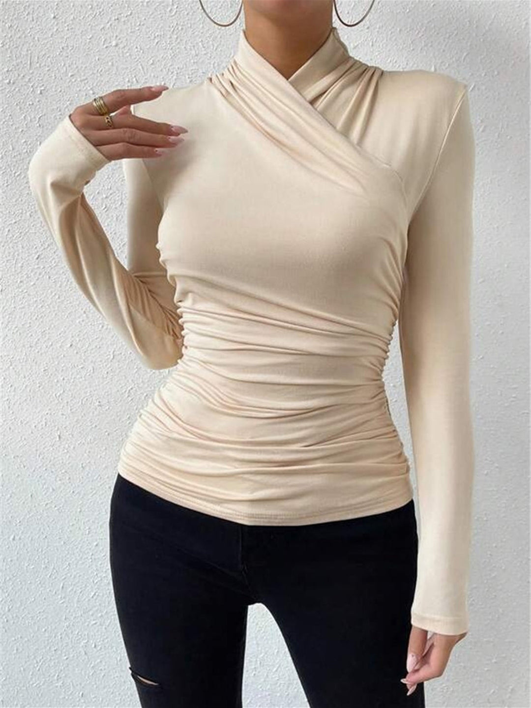 Cozy yet chic long sleeve top featuring a stylish draped crossover design.