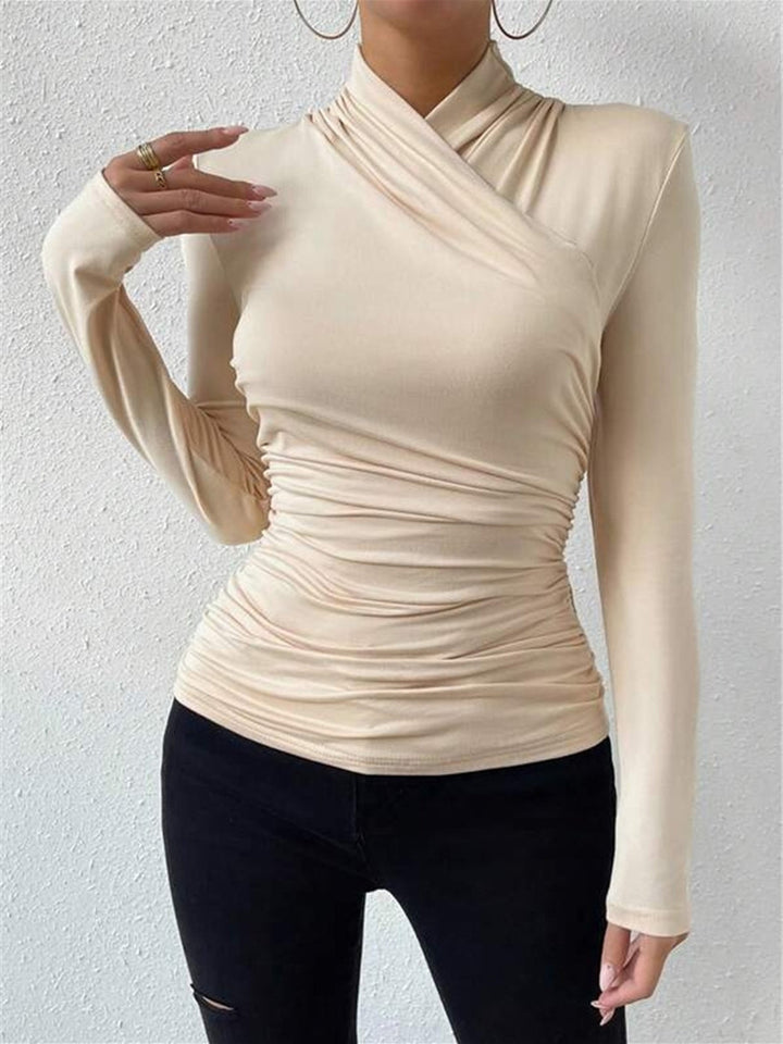 Cozy yet chic long sleeve top featuring a stylish draped crossover design.