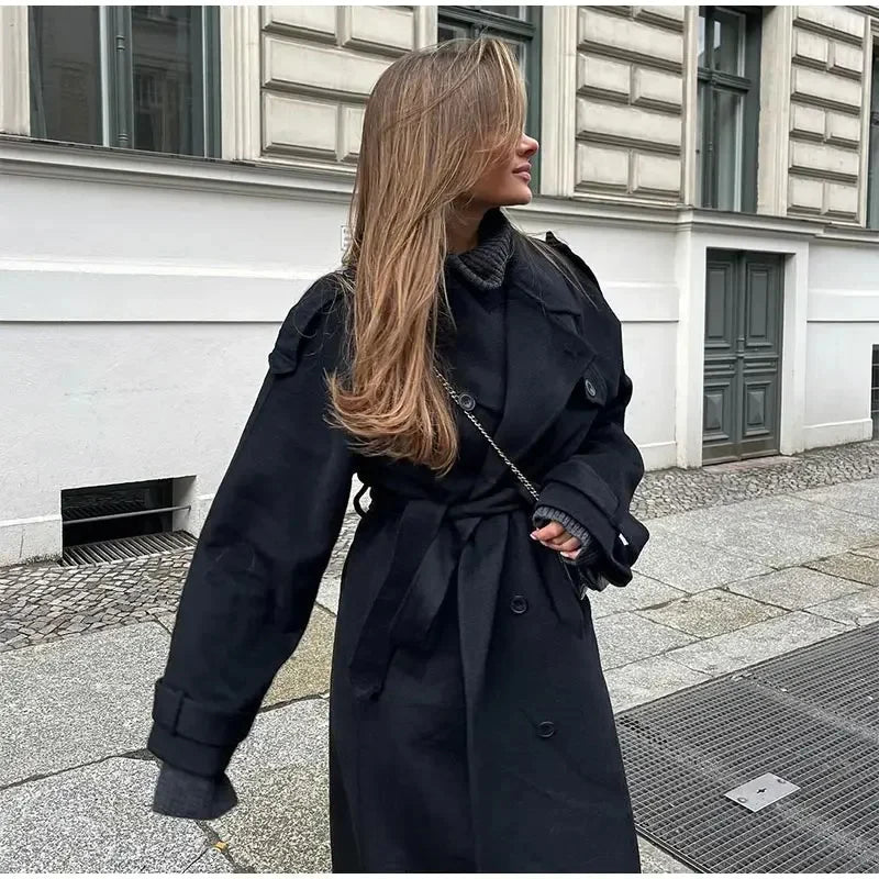 Stylish women's black winter coat, featuring a double-breasted front and a flattering longline cut.