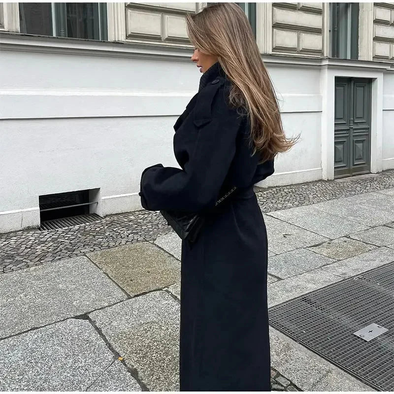 Sophisticated women's outerwear: a classic black double-breasted longline coat for urban elegance.
