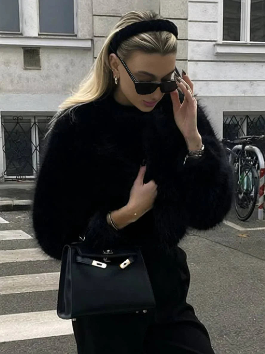 Close-up of plush faux fur on a women's elegant winter coat, showcasing luxury outerwear.