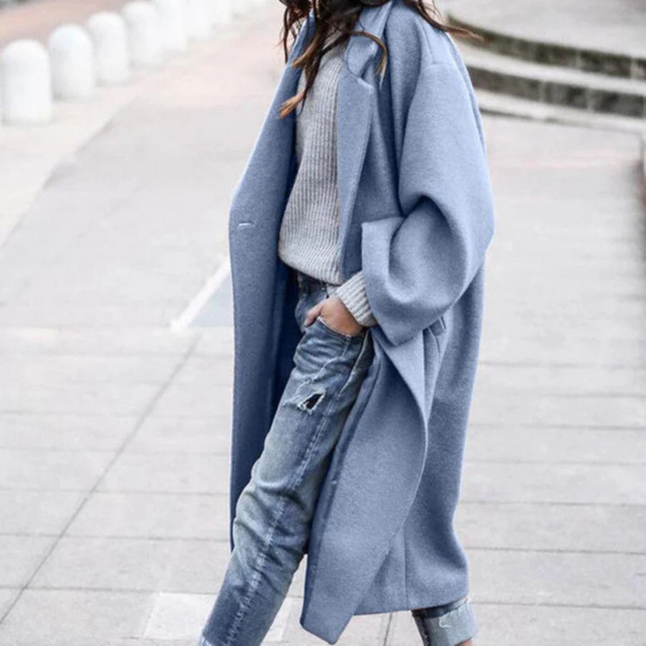 Model wearing a fashionable black long trench coat, showcasing its elegant winter style.