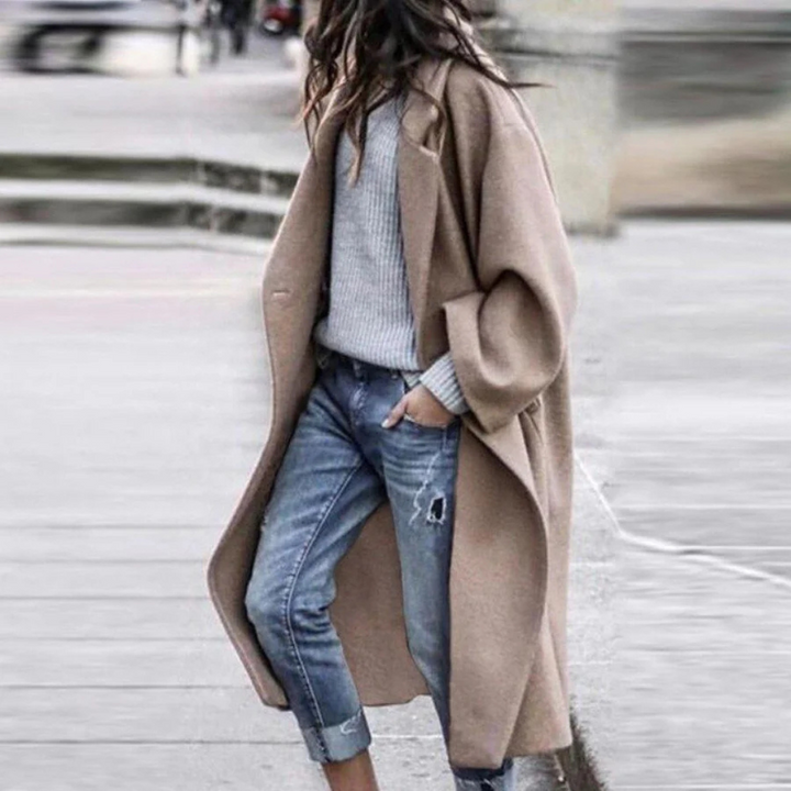 Side view of a women's warm, long trench coat, highlighting its sophisticated outerwear design.
