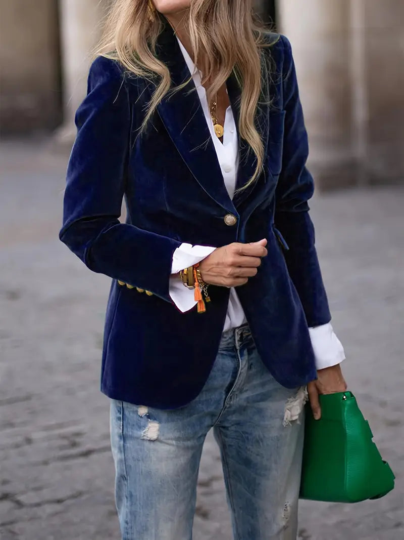 Model wearing a women's elegant velvet blazer in a sophisticated evening setting.