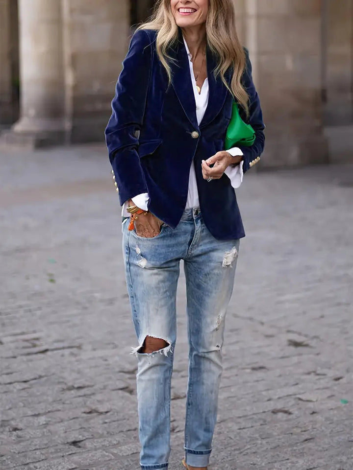 Detail shot of buttons and lapels on a luxurious women's velvet blazer.