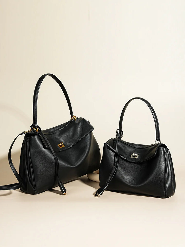 Chic women's fold-over bag in a structured design, featuring a secure turn-lock and versatile strap.