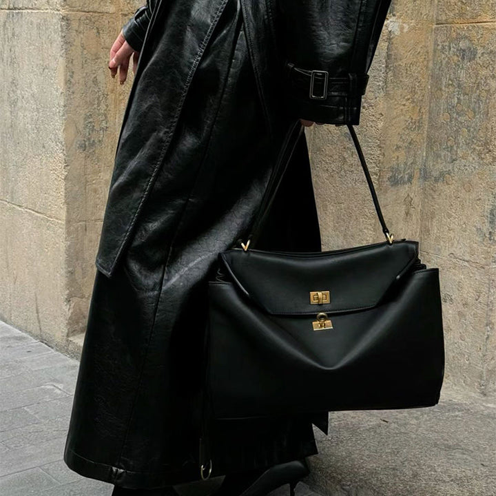 Stylish structured handbag for women, elegant fold-over design with a polished silver turn-lock.
