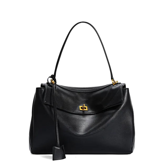 Elegant midi bag for women, featuring a structured fold-over silhouette and classic turn-lock hardware.