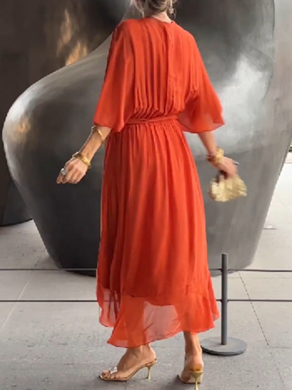 Flowing V-neck party dress with short sleeves, chic for cocktail parties.