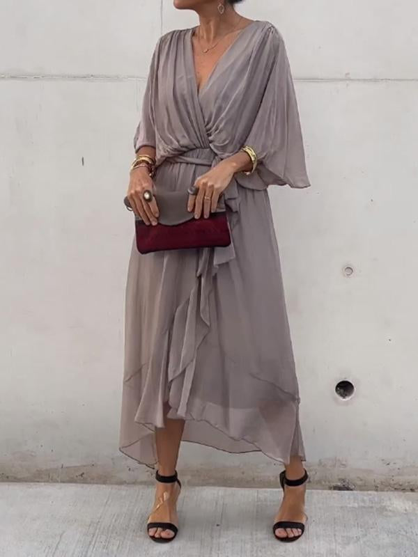Comfortable flowing V-neck dress, short sleeves, elegant for evening wear.