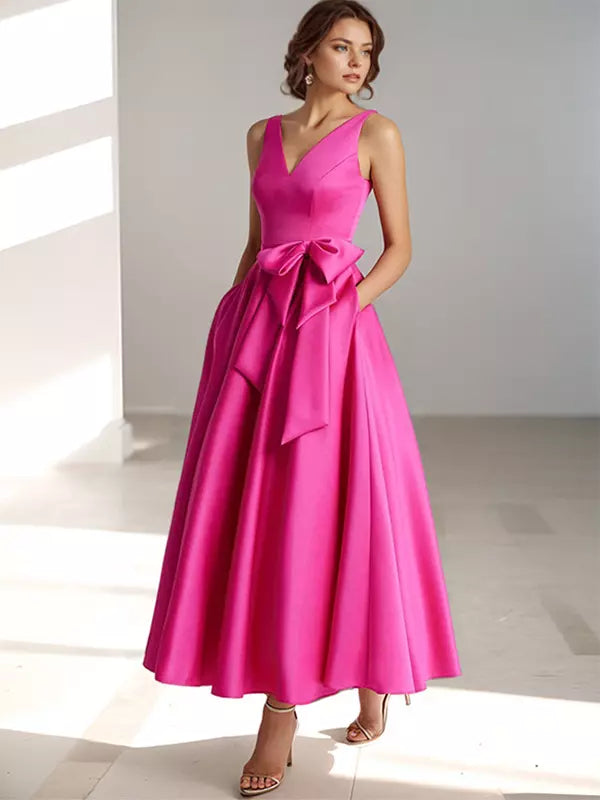 Stylish women's midi dress featuring a flattering V-neck and a decorative bow waist.