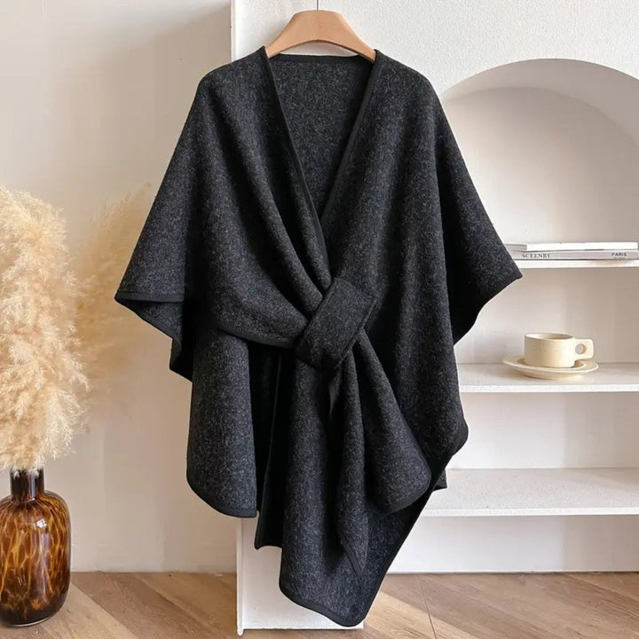 Close-up of the cozy fabric on a stylish women's shawl coat, showing texture.