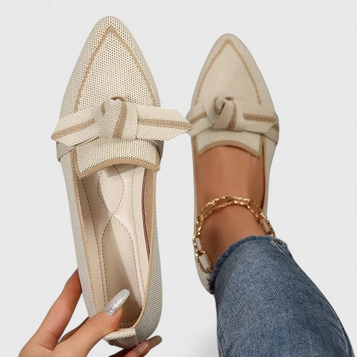 Women's comfortable slip-on flats with a stylish pointed toe and subtle knot detail.