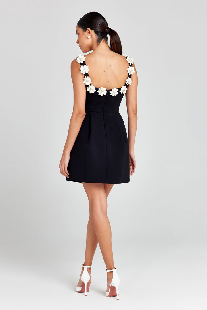 Stylish summer mini dress featuring delicate floral appliqué, a must-have.