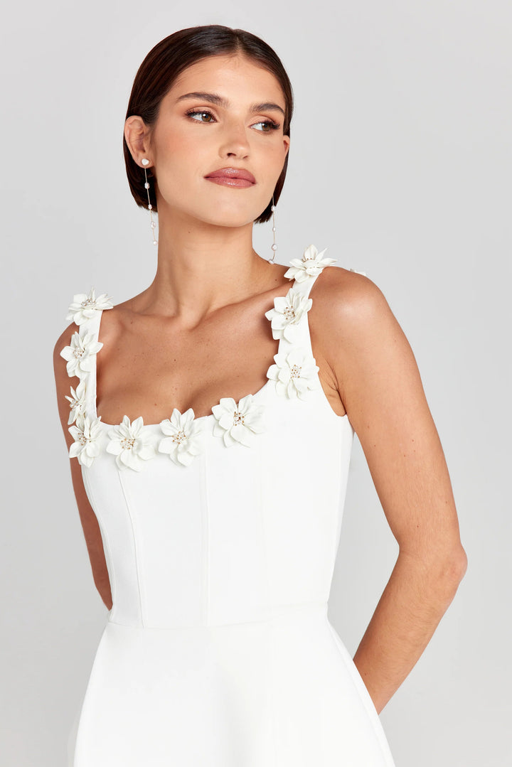 Light and airy summer mini dress with intricate floral appliqué details.
