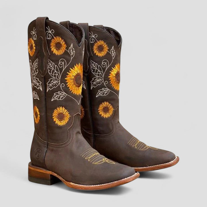 Women's floral embroidered cowgirl boots with low block heel, faux leather western style.
