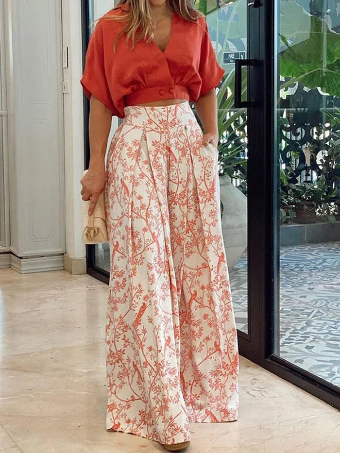 Women's floral print two-piece set with flowing wide-leg pants.
