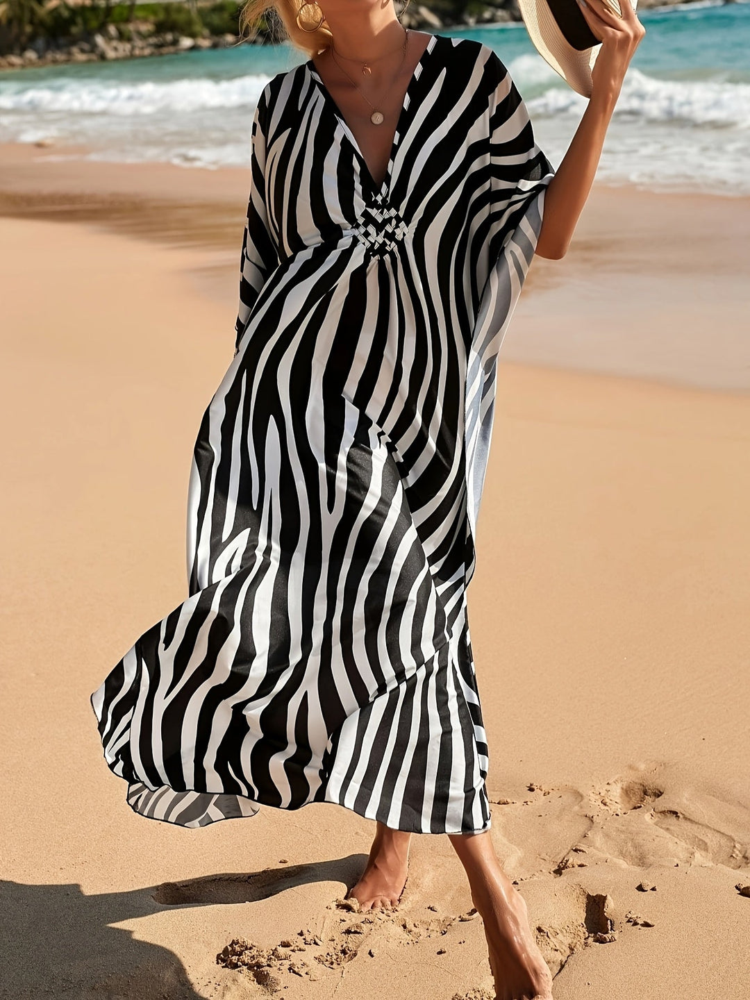 Comfortable flowing women's zebra print maxi dress. Stylish V-neck beach & resort wear, perfect for summer.