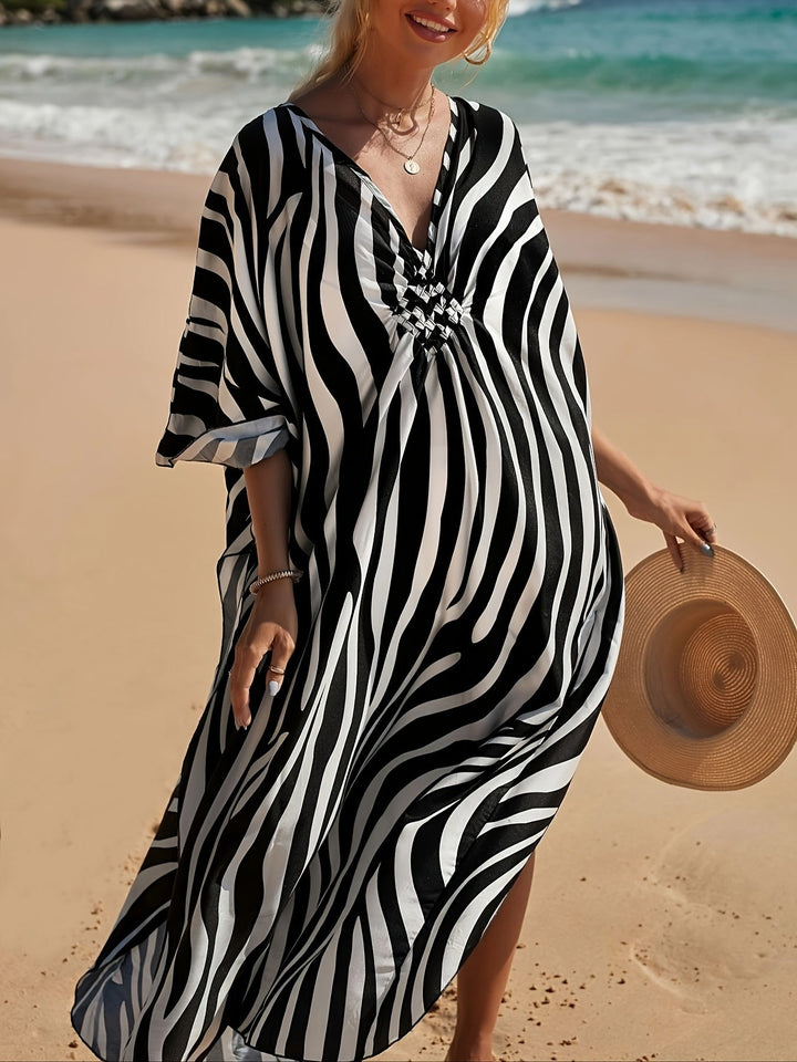 Elegant women's flowy zebra print maxi beach dress. V-neck design, great for casual summer fashion & holiday outfits.