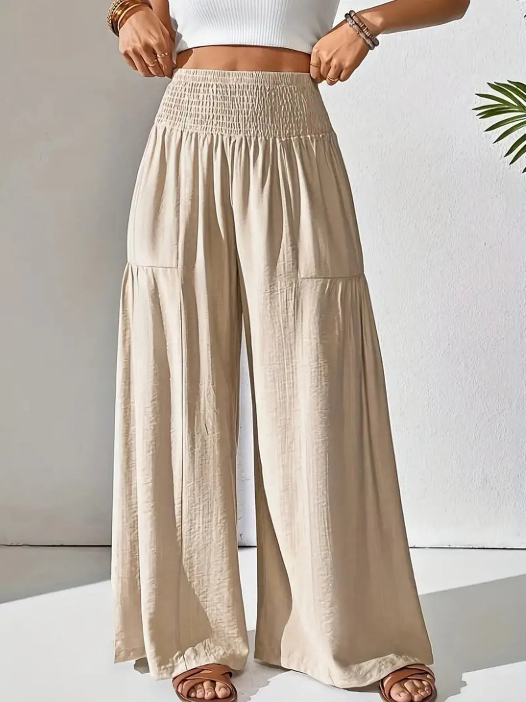 Close-up of the comfortable smocked waistband on women's wide leg flowy pants.