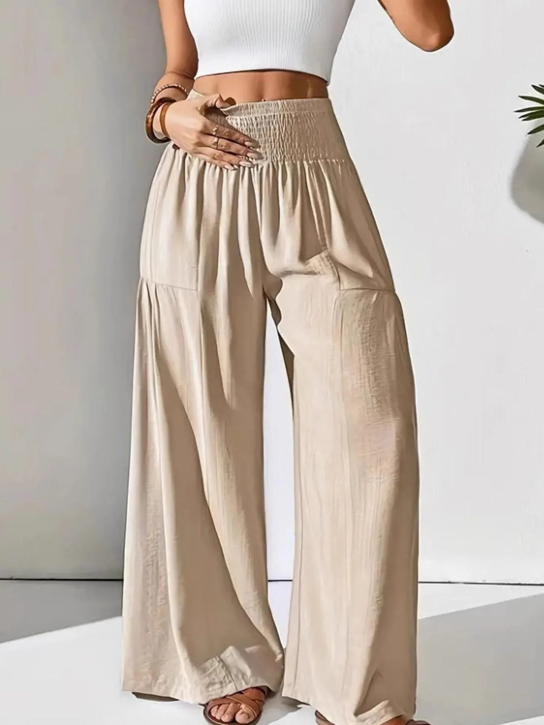 Stylish women's wide leg pants featuring a flowy silhouette and smocked elastic waist.