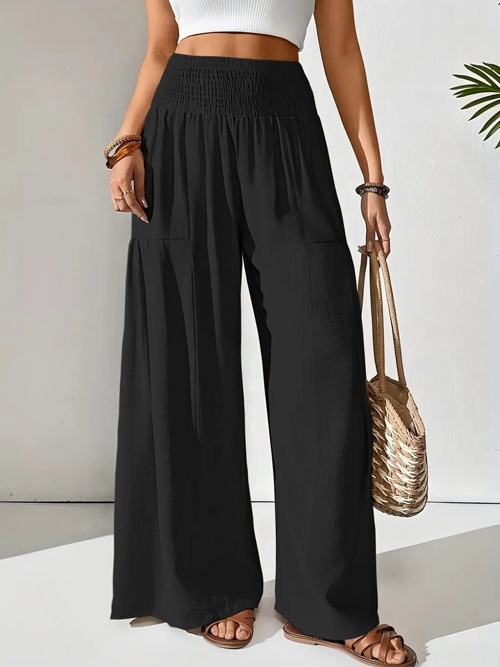 Athleisure look: women's flowy wide leg pants with a flattering smocked waist design.