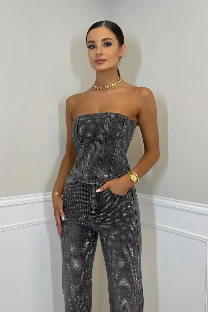 Matching women's glitter high-waist jeans and a sparkling shimmer top. Trendy two-piece set fashion.