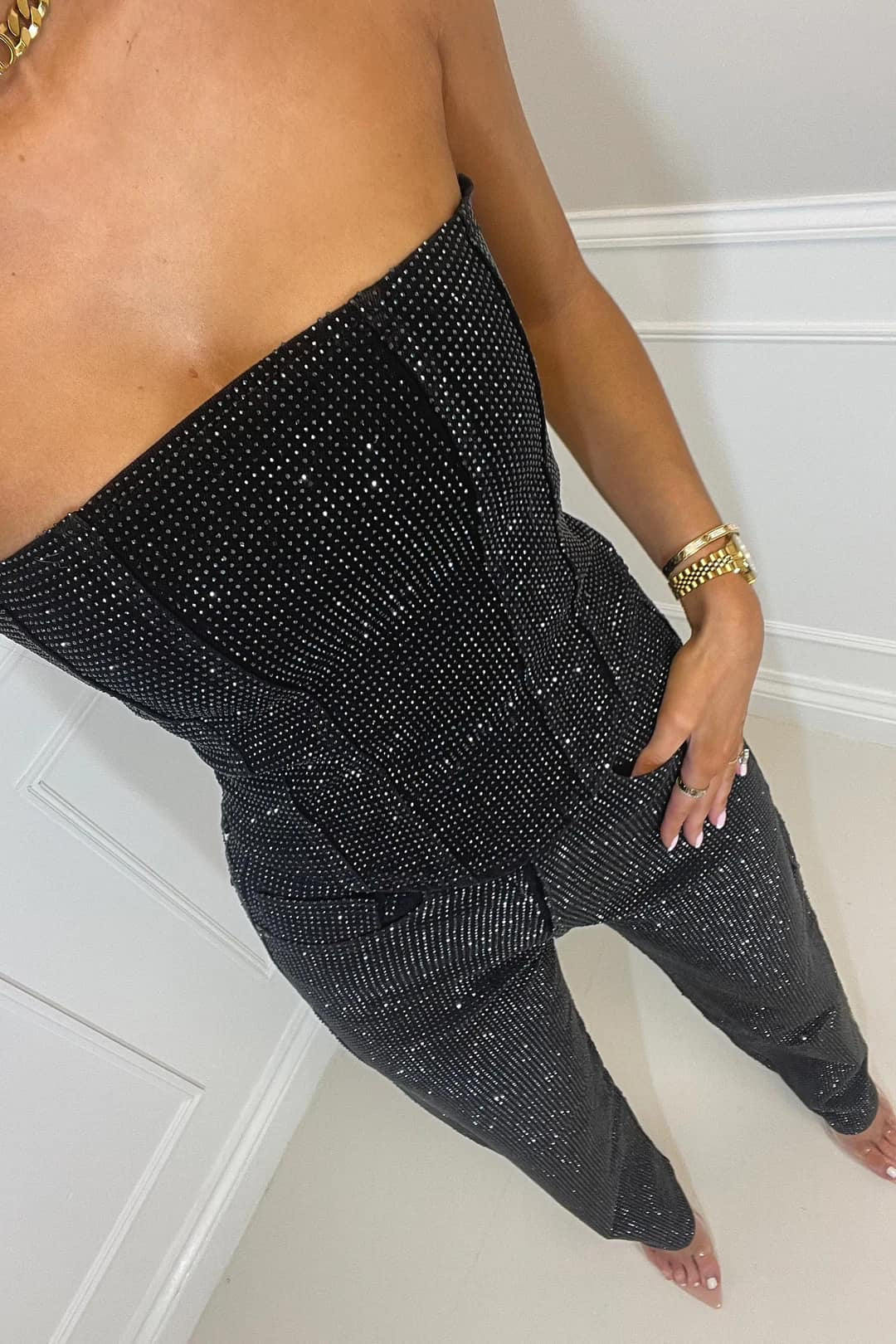 Elegant women's shimmer top & matching glitter high-waist jeans set. Perfect party wear attire.