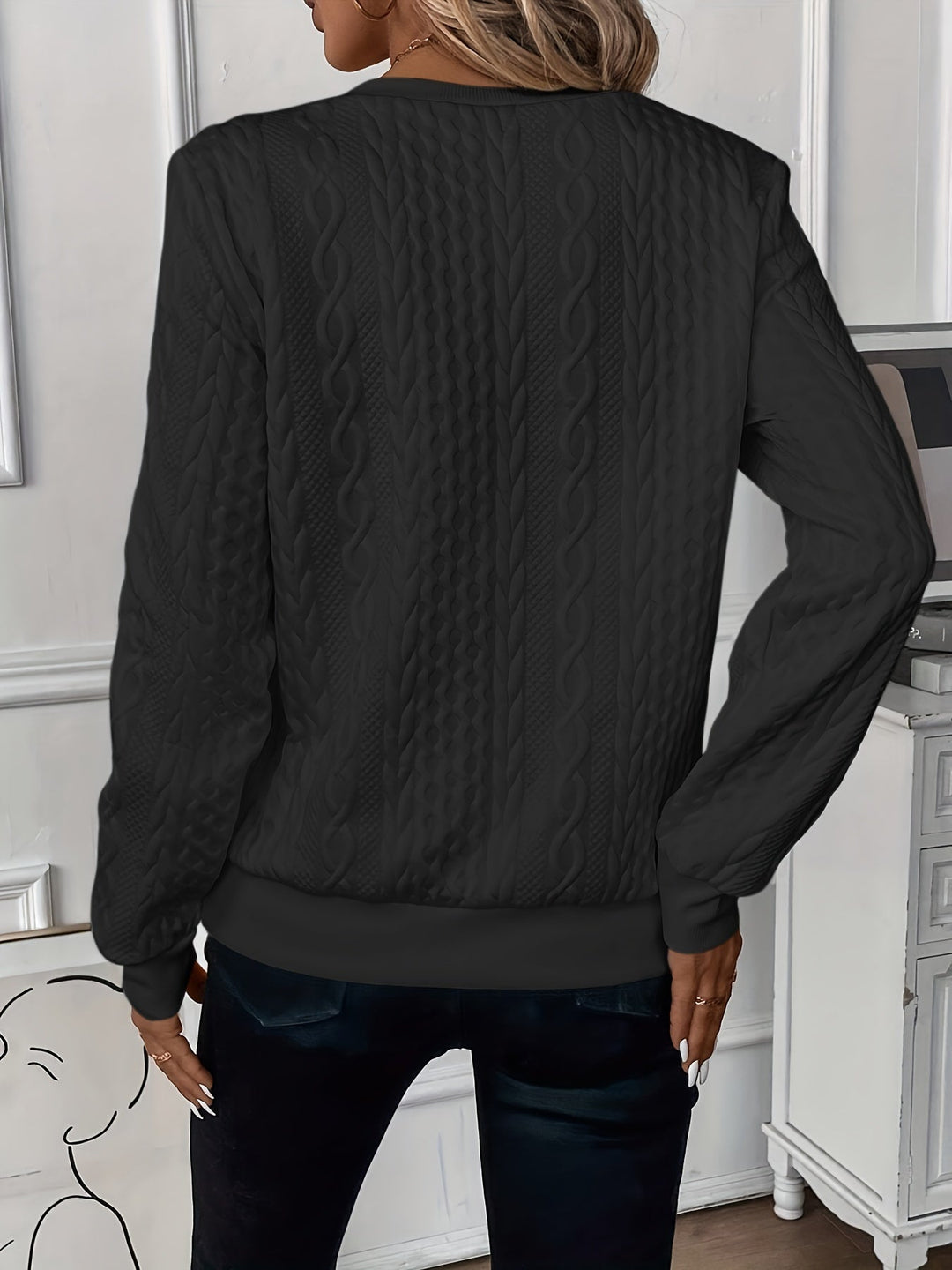 Close-up of textured women's half-zip jumper, ring pull, ribbed hem; quality detailing.