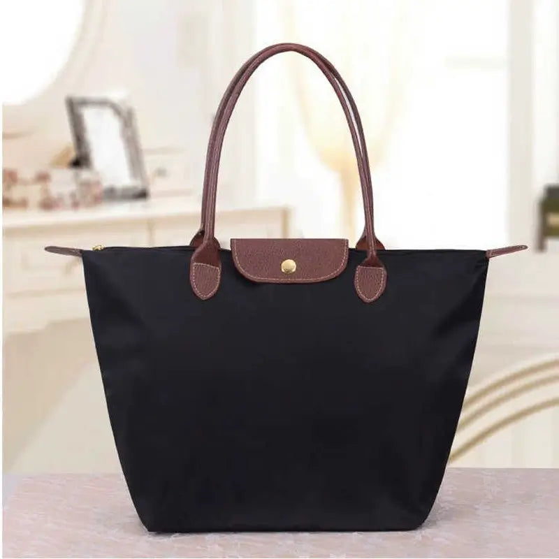 Elegant women's black leather shoulder handbag, perfect for office or evening wear.