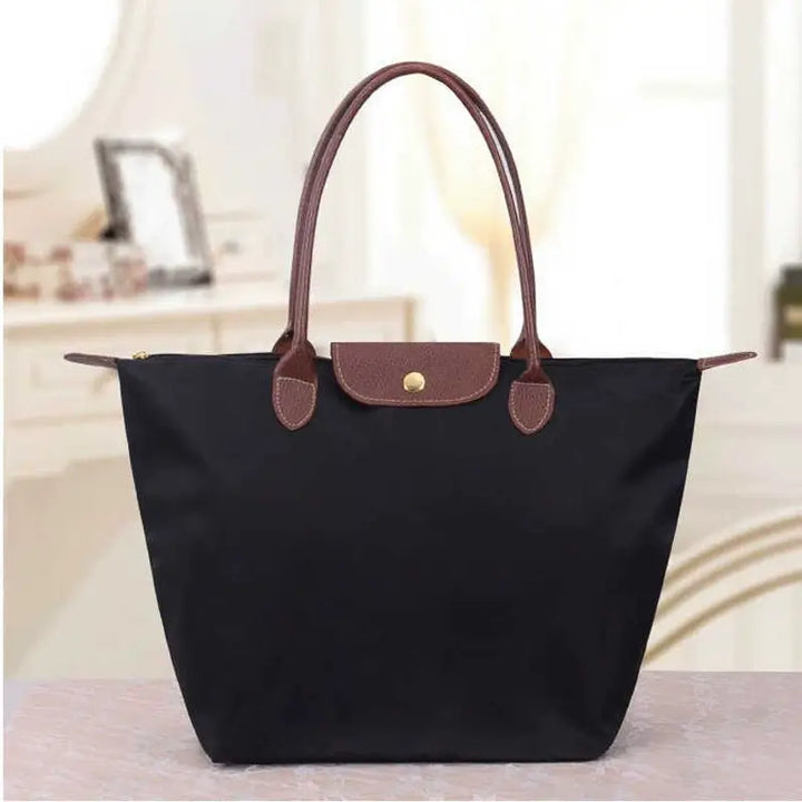 Elegant women's black leather shoulder handbag, perfect for office or evening wear.
