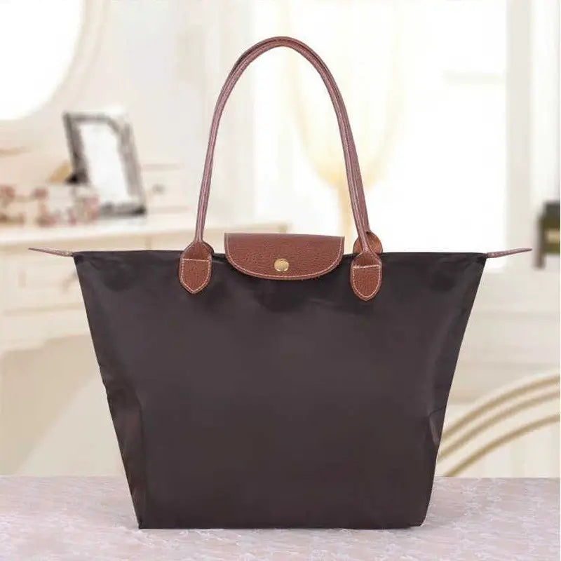 Stylish women's fashion handbag with gold accents, a timeless accessory for any outfit.