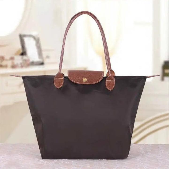 Stylish women's fashion handbag with gold accents, a timeless accessory for any outfit.