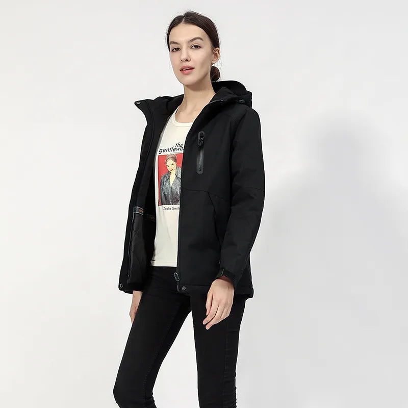 Model wearing women's black heated hooded jacket in cold weather