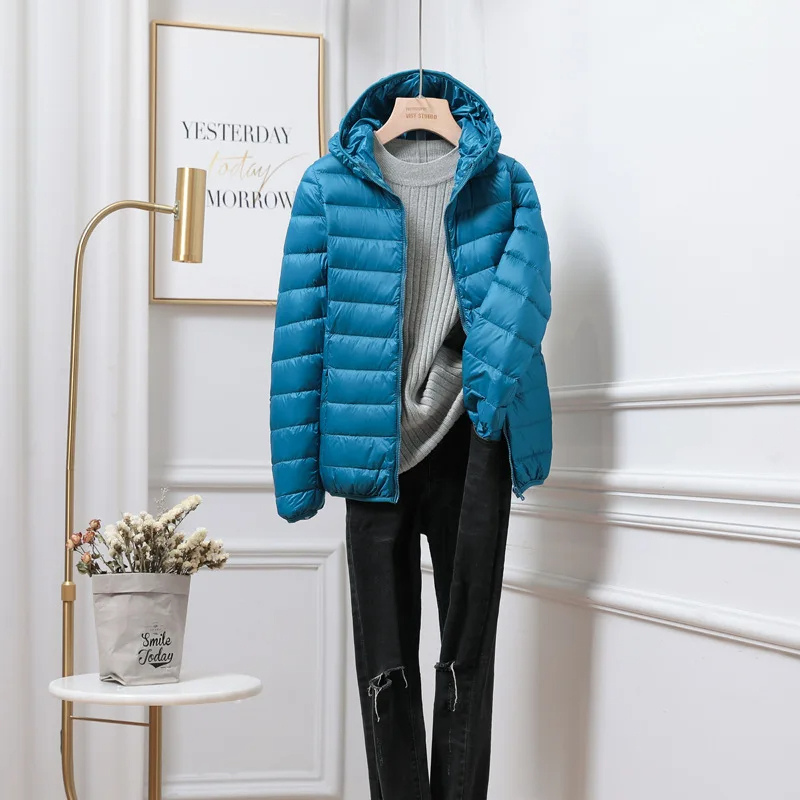 Elegant womens puffer jacket with hood, combining warmth and modern design