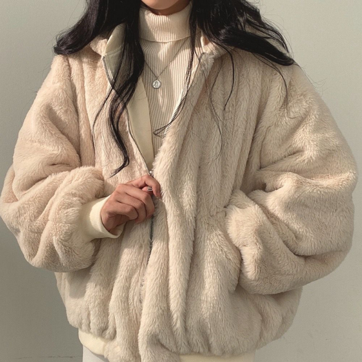 Back view of a women's Isla hooded winter coat, showing its sleek reversible style for versatility.