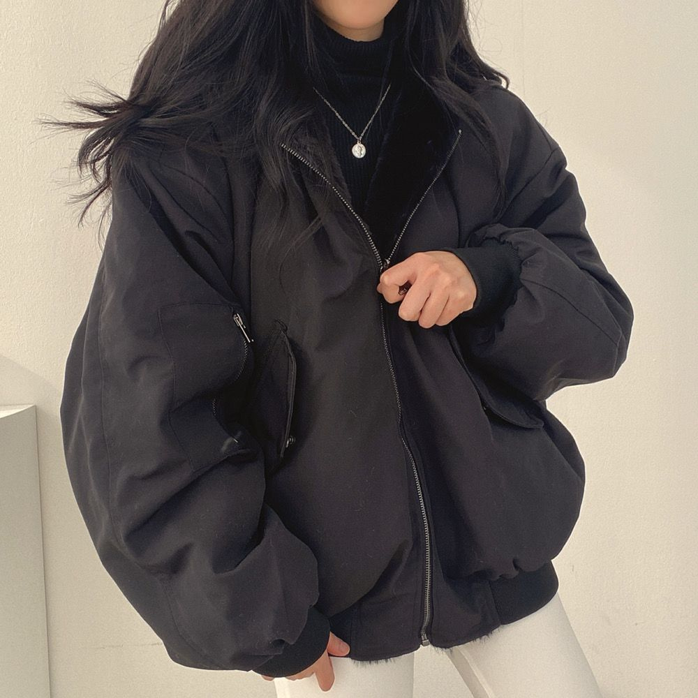 Cozy and warm Isla women's reversible winter jacket, featuring a protective hood for outdoor adventures.