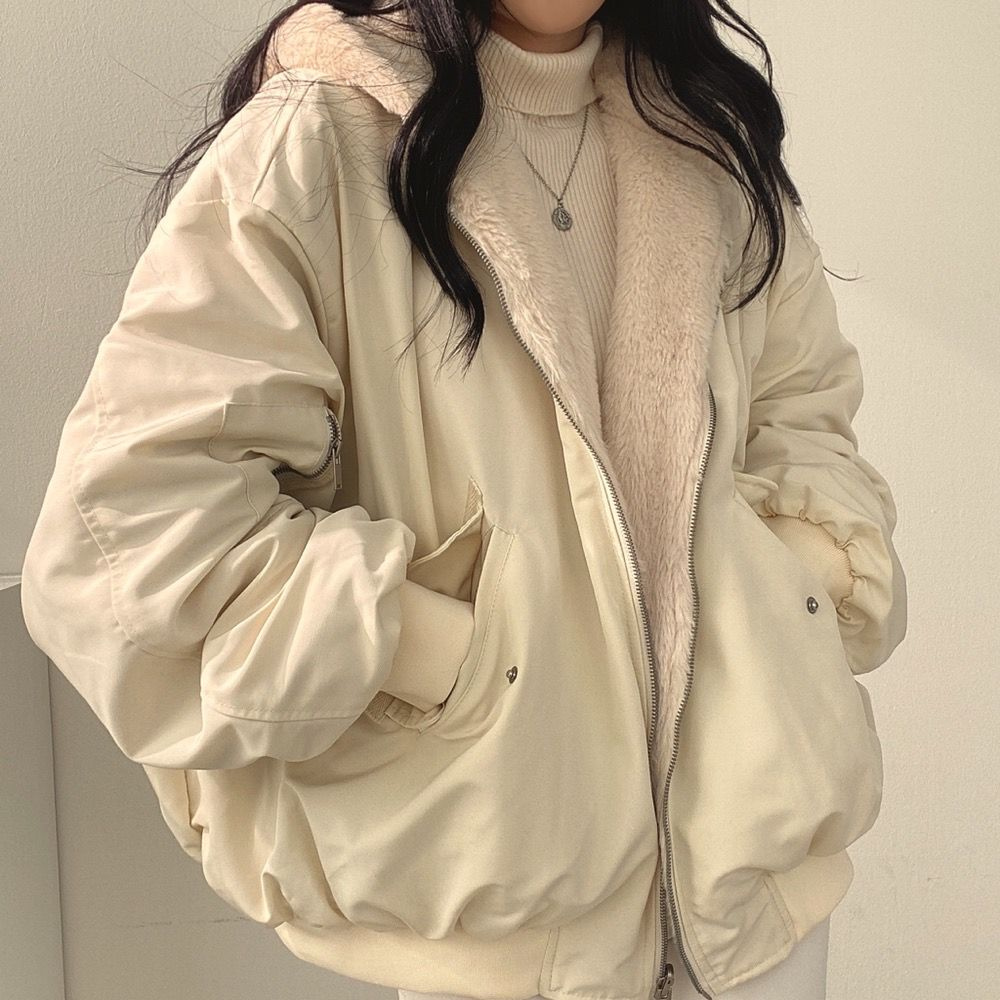 Full-length view of a woman wearing the Isla reversible winter coat with hood, demonstrating fit.