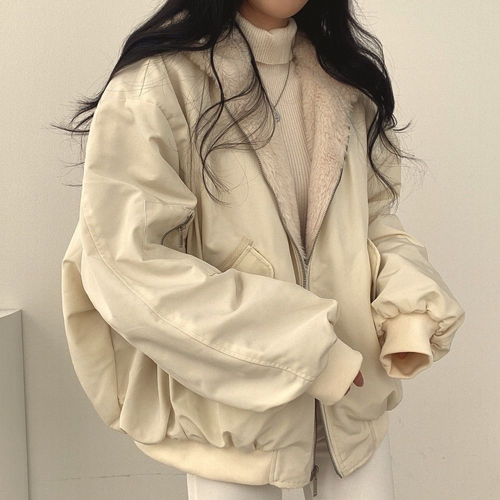 Front view of the Isla reversible women's winter jacket, highlighting its hooded design and zip closure.